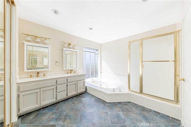 full bathroom featuring a sink, double vanity, a stall shower, and a whirlpool tub