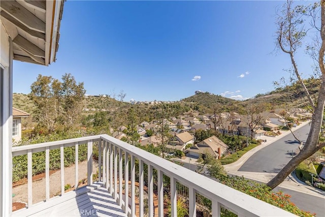 balcony featuring a residential view and a mountain view