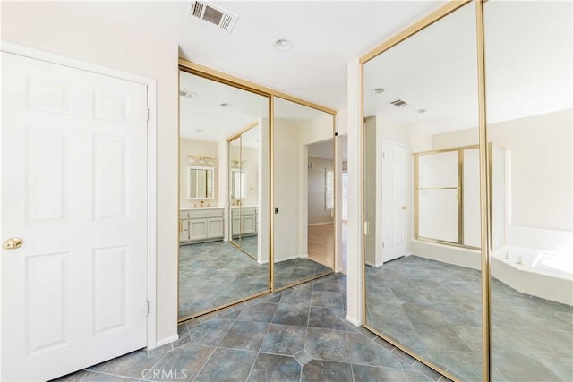 bathroom featuring a stall shower, visible vents, a bath, and vanity