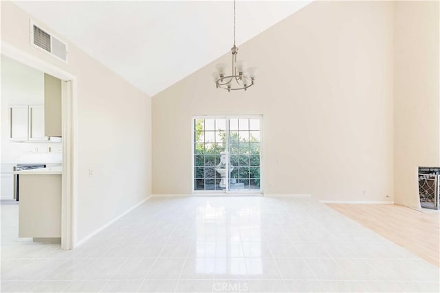 interior space with baseboards, visible vents, high vaulted ceiling, and an inviting chandelier