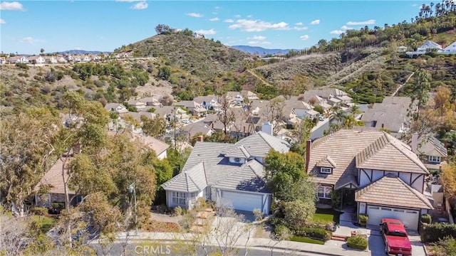 birds eye view of property featuring a mountain view and a residential view