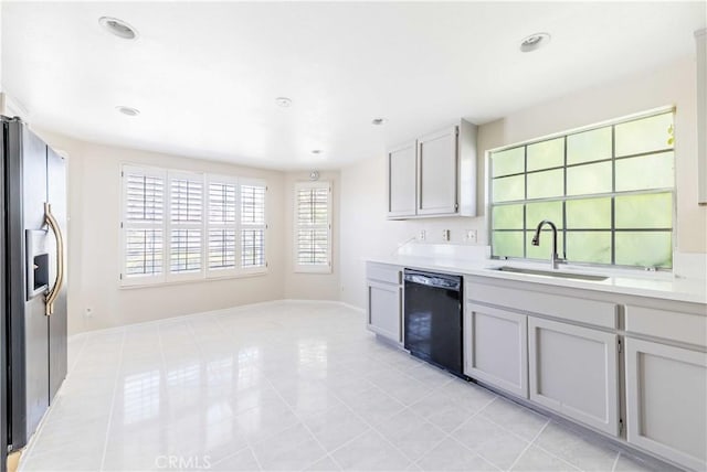 kitchen featuring stainless steel refrigerator with ice dispenser, a sink, recessed lighting, light countertops, and dishwasher