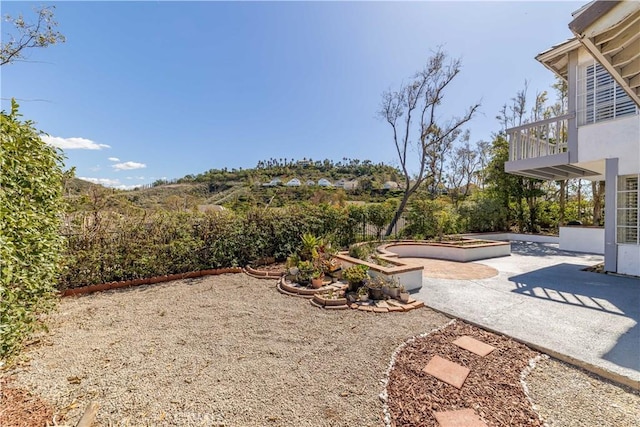 view of yard featuring a patio area and a balcony