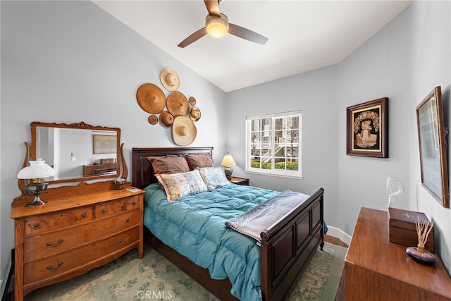 bedroom featuring ceiling fan, baseboards, lofted ceiling, and carpet floors