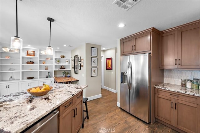 kitchen featuring visible vents, dark wood finished floors, decorative backsplash, stainless steel refrigerator with ice dispenser, and open shelves