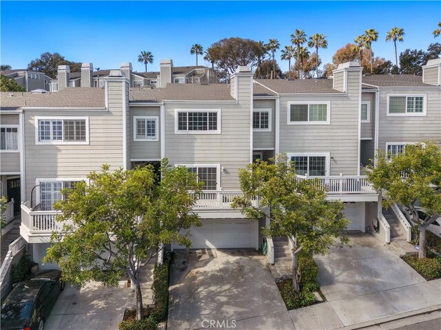 33121 Ocean Rdg, Dana Point, CA 92629 - back of house featuring a garage, concrete driveway, and a chimney