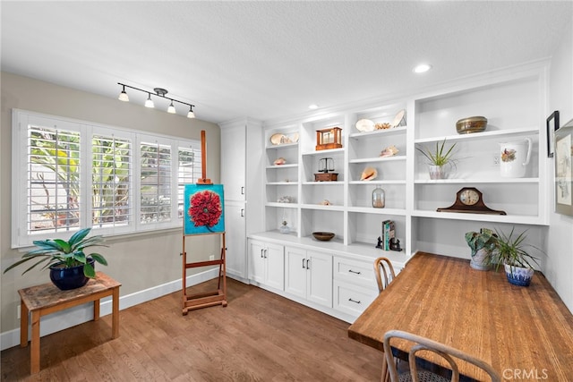 living area featuring recessed lighting, baseboards, a textured ceiling, and wood finished floors