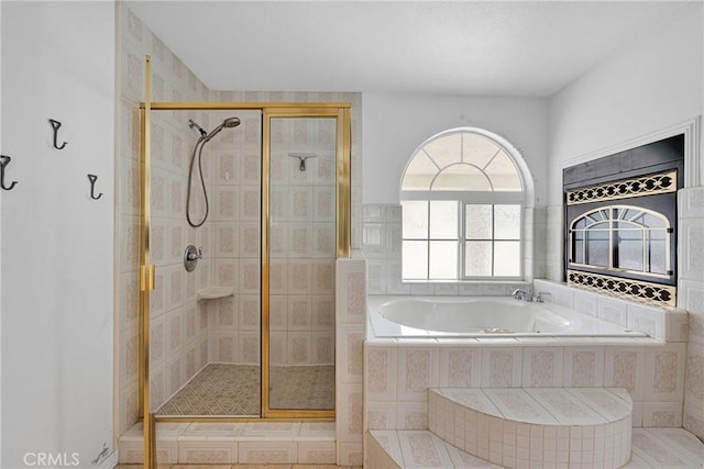 bathroom with a shower stall and a garden tub