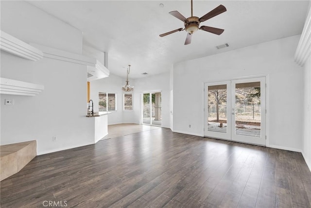 unfurnished living room featuring visible vents, ceiling fan with notable chandelier, a sink, wood finished floors, and french doors