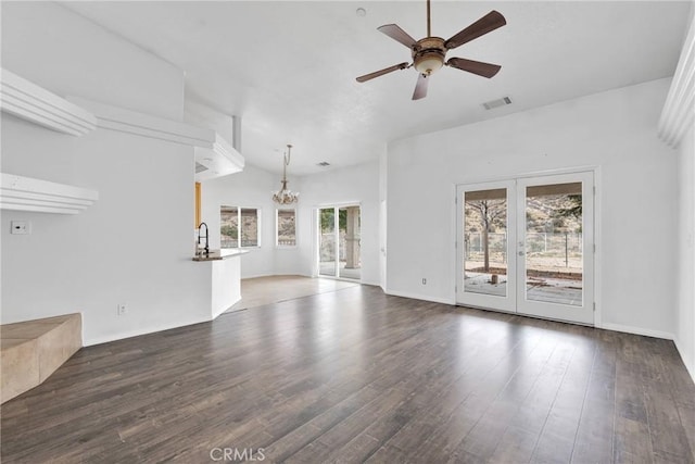 unfurnished living room featuring wood finished floors, visible vents, and ceiling fan with notable chandelier