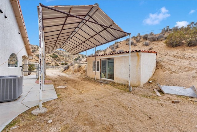 exterior space featuring fence, cooling unit, and a gate