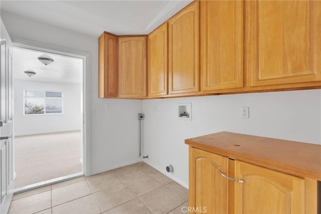 laundry area with cabinet space, light tile patterned floors, baseboards, light colored carpet, and hookup for a washing machine