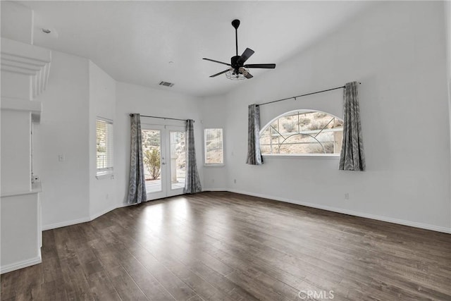 empty room with visible vents, a ceiling fan, wood finished floors, french doors, and baseboards