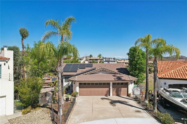 22176 Dogie Pl, Canyon Lake, CA 92587 - view of front of house with roof mounted solar panels, stucco siding, a tiled roof, driveway, and an attached garage