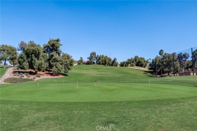 22176 Dogie Pl, Canyon Lake, CA 92587 - view of home's community featuring a putting area, view of golf course, and a lawn