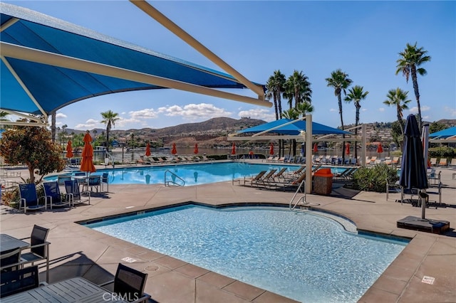 22176 Dogie Pl, Canyon Lake, CA 92587 - community pool with a mountain view and a patio area