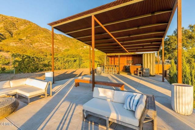 view of patio / terrace with an outdoor living space and a mountain view