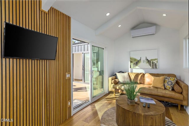 living area featuring light wood finished floors, recessed lighting, lofted ceiling with beams, and a wall unit AC