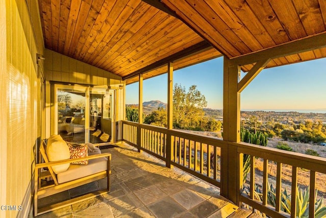 sunroom featuring wooden ceiling and vaulted ceiling