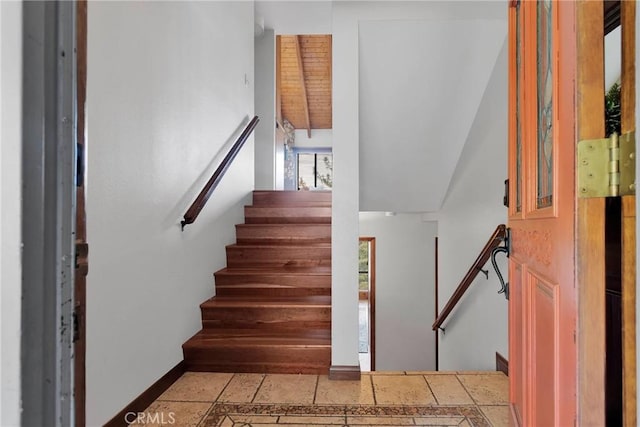 stairway featuring lofted ceiling