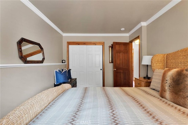 bedroom featuring crown molding and a closet