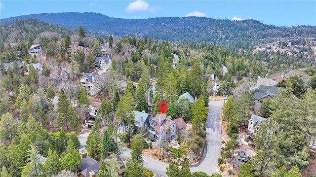 aerial view featuring a view of trees and a mountain view