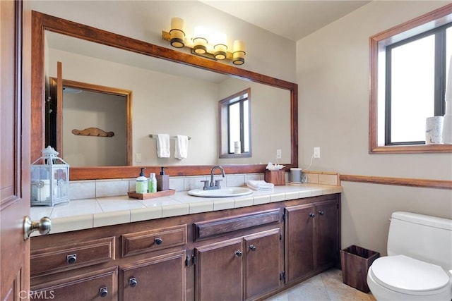 bathroom featuring vanity, tile patterned floors, and toilet