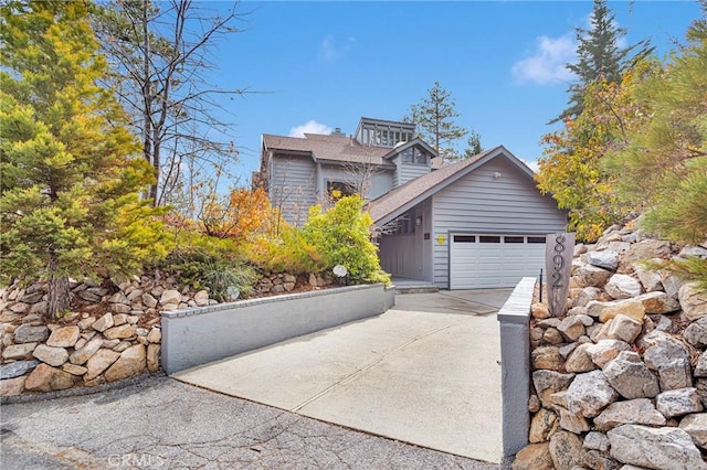 view of front of property featuring a garage and concrete driveway