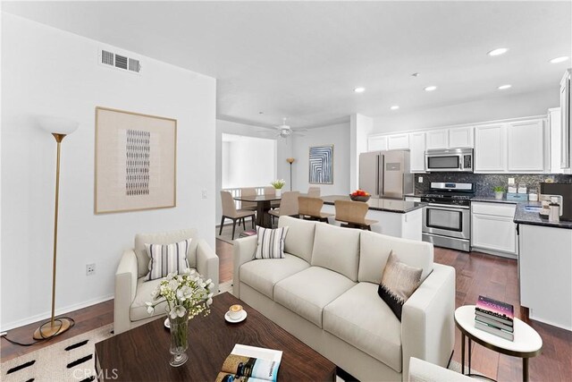 living room featuring dark wood-type flooring, recessed lighting, visible vents, and ceiling fan