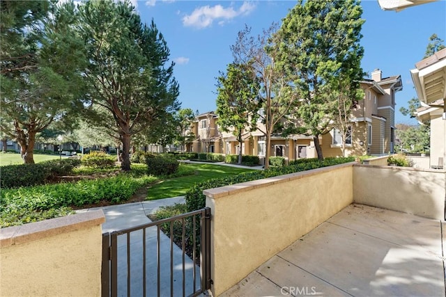 view of property's community with a residential view, fence, and a gate