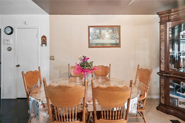 dining room with tile patterned floors and baseboards