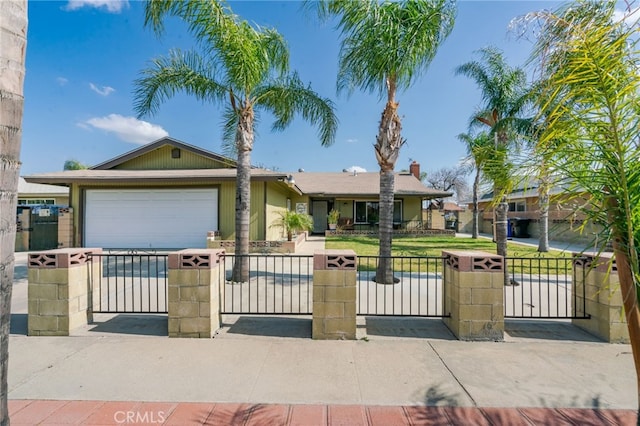 ranch-style house with a garage, fence, driveway, and a gate