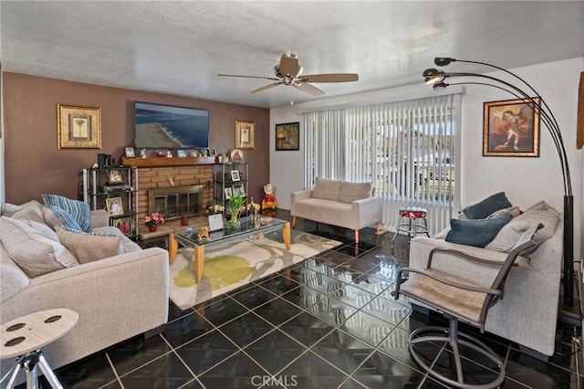 living area featuring tile patterned floors, a brick fireplace, a textured ceiling, and a ceiling fan