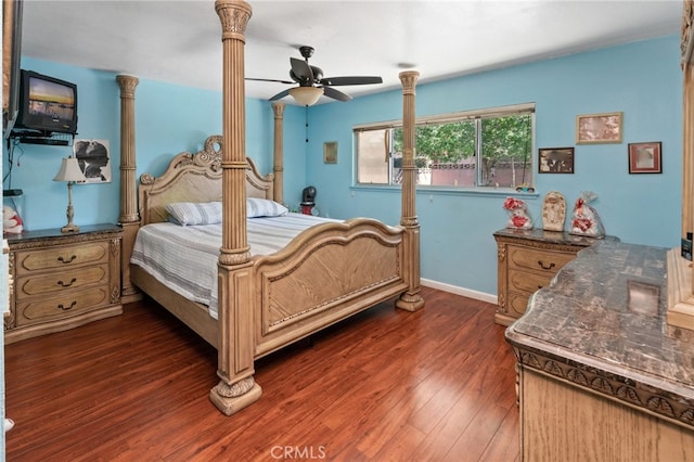 bedroom with decorative columns, wood finished floors, baseboards, and ceiling fan