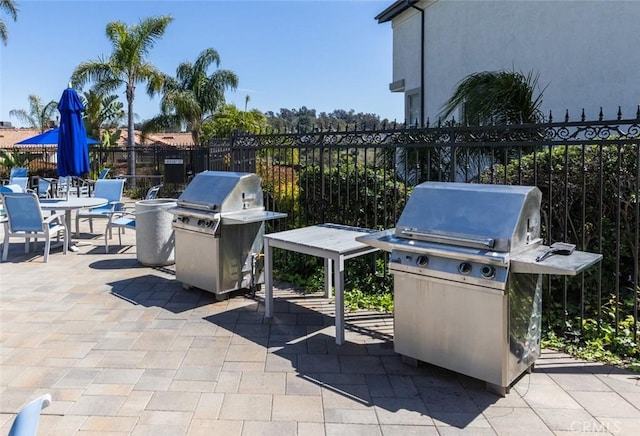 view of patio / terrace with area for grilling and fence