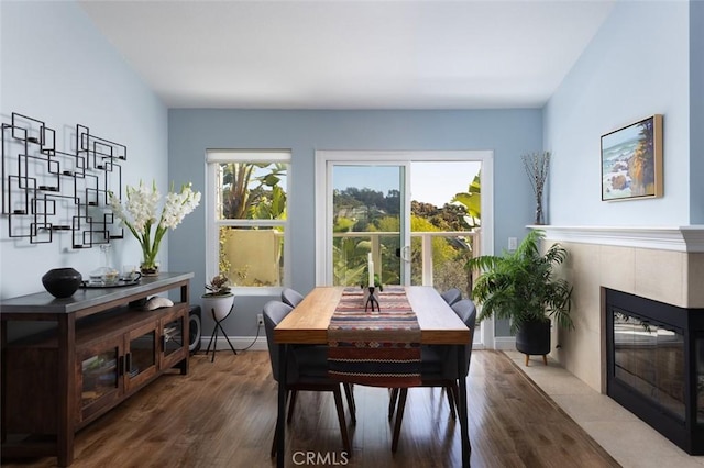 dining room with a wealth of natural light, baseboards, and wood finished floors