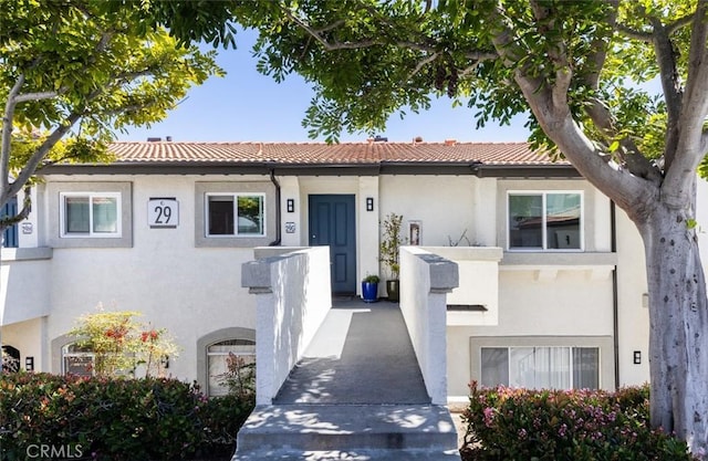 view of front of home featuring stucco siding and a tile roof