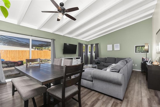 dining space featuring baseboards, vaulted ceiling with beams, ceiling fan, and wood finished floors