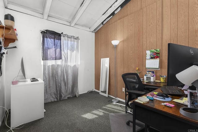 home office with beam ceiling, carpet flooring, and wooden walls