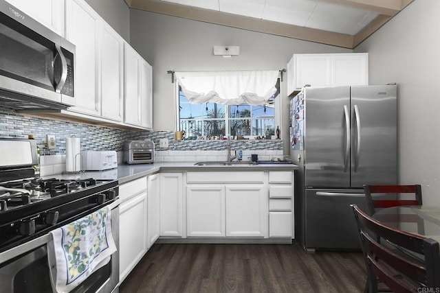 kitchen featuring decorative backsplash, white cabinetry, appliances with stainless steel finishes, and a sink