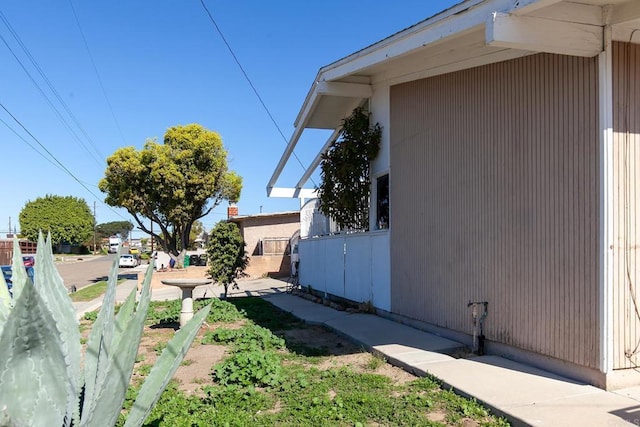 view of side of home featuring fence