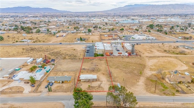 birds eye view of property with a mountain view