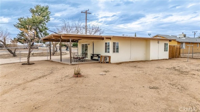 rear view of house featuring a patio area and fence