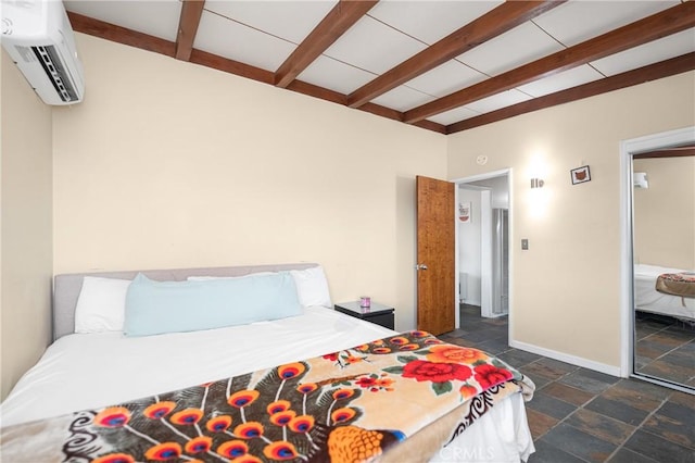 bedroom featuring stone tile floors, baseboards, beamed ceiling, and a wall mounted AC