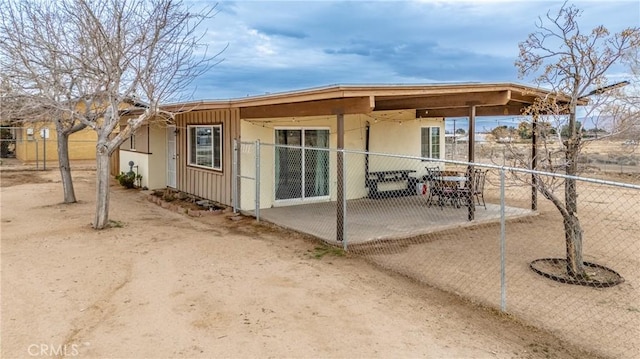 view of outbuilding featuring fence