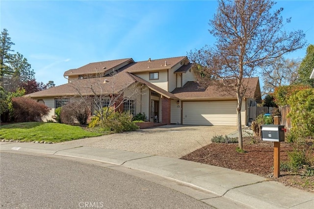 traditional home featuring an attached garage, driveway, a front lawn, and fence