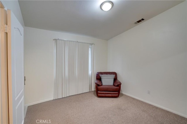 sitting room with visible vents, carpet floors, and baseboards