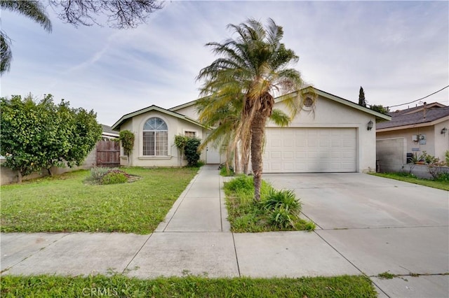 view of front facade featuring a front lawn, fence, concrete driveway, stucco siding, and a garage