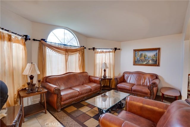 living area with light tile patterned flooring and vaulted ceiling