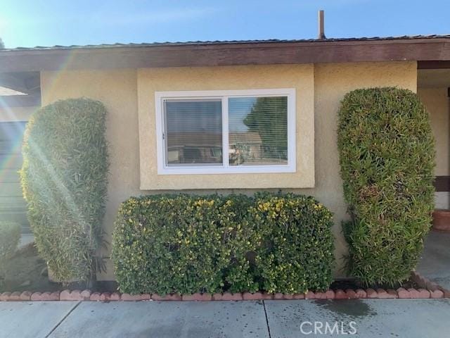 view of side of home featuring stucco siding